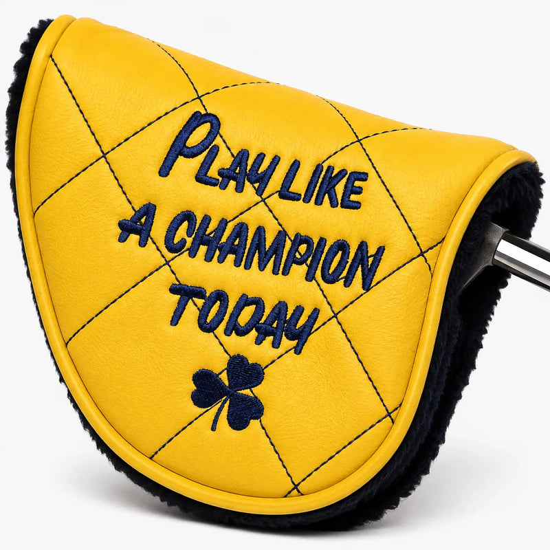 Angled view of a yellow quilted leather-style mallet putter headcover with shearling-lined opening and putter shaft showing, embroidered with Play Like A Champion Today. Studio product photo on white background - HeadCaddy